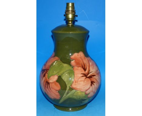 A Moorcroft pottery table lamp with amaryllis on green ground, 13" overall