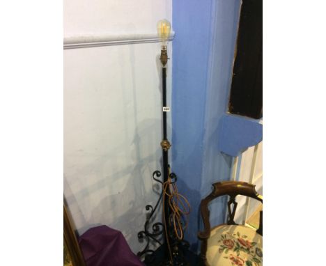 A wrought iron standard lamp