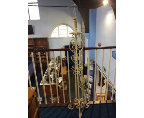 A wrought iron standard lamp