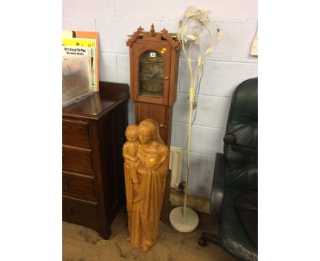 A carved figure group, Mary and child, a clock and a lamp