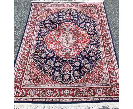 GOOD PERSIAN RUG with large centred medallion in reds and blues with floral patterns, 272 x 395cmsProvenance: private collect