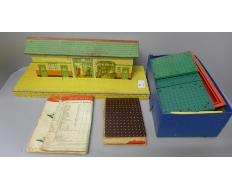 A Hornby tin-plate station and a box of Bayko 