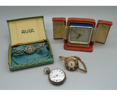 A cased travel alarm clock, a silver fob watch and two lady's cocktail wristwatches 