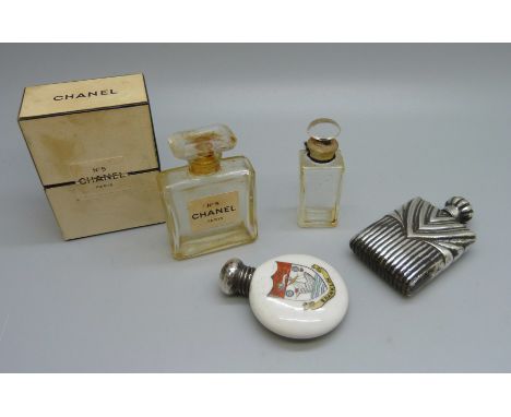 A silver topped crested scent flask, Birmingham 1909, a Chanel No.5 perfume bottle and two others 