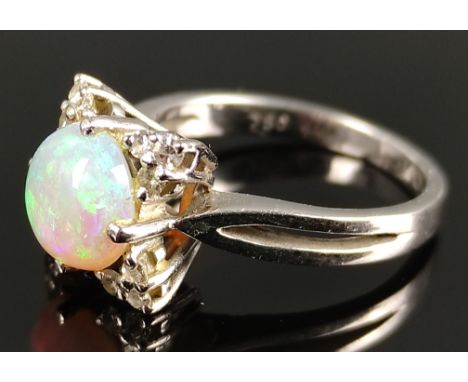 Opal-Ring, mittig runder Opal-Cabochon, besetzt mit 12 Brillanten, 750/18K Weißgold, 4g, Ringgröße 48