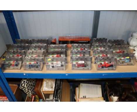 A quantity of scale model Formula 1 cars and a lorry