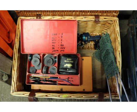 A wicker picnic hamper and contents of various fishing related items to include reels, floats, various plates and other acces