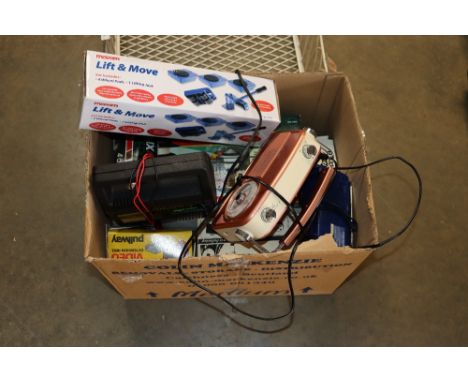 A box containing various items to include light system; radio; lift and move four wheel pads etc