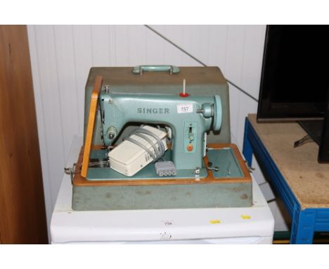 A Singer electric sewing machine in fitted case, sold as collectors item