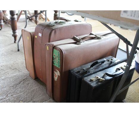 Three various vintage travel cases and two briefcases
