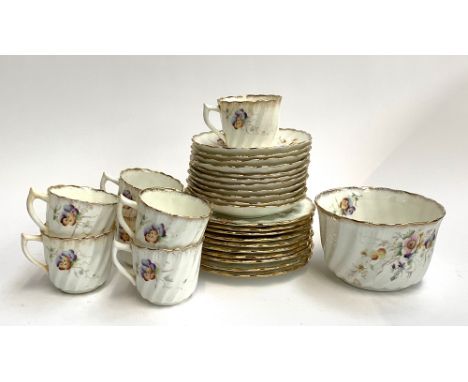 A china tea set with floral decoration comprising cake plates (2), side plates (10), saucers (11), cups (8) and sugar bowl 