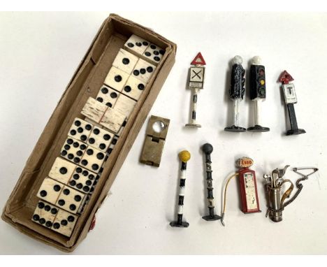 A quantity of bone dominoes, together with a small quantity of die cast road signs to include traffic lights, Esso petrol pum