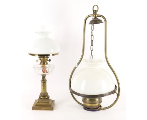 A gilt brass and glass oil lamp, of columnar form, white opaque shade, 65cm high; together with a hanging paraffin lamp, with