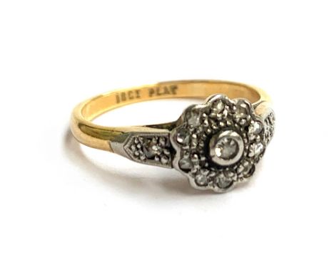 An 18ct gold and platinum ring set with diamond chips in a floral cluster, approx. 2.8g, size K 