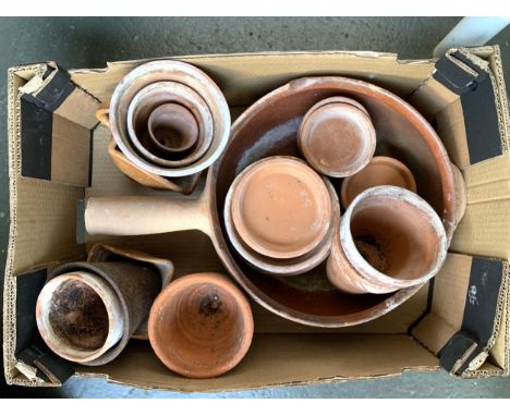 A mixed box of terracotta garden pots and saucers 