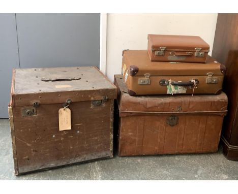 A large canvas and leather suitcase, 61x53x50cmH; together with a metal storage trunk and several others 