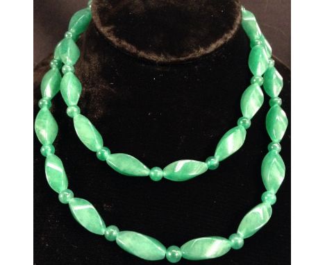 A faceted green jade bead necklace, 76cm long 