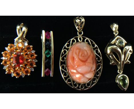 A carved coral pendant, central oval carved floral panel, surrounded by an open cast S scroll 9ct gold frame;  a diamond, fir