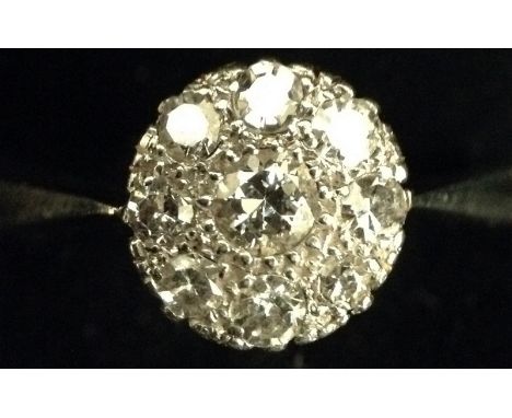 A diamond nine stone cluster ring, central round brilliant cut diamond, surrounded by a band of eight smaller conforming diam