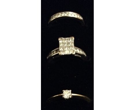 A diamond checker board ring, rectangular platform, set with twelve princess cut diamond arranged in a checkered panel, betwe