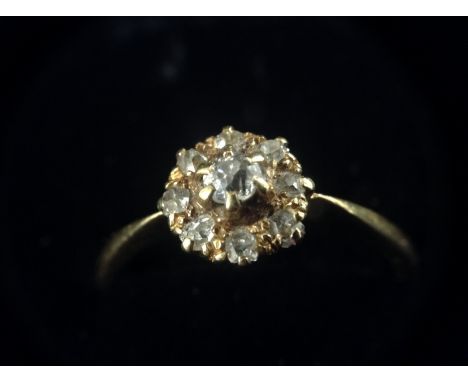 A Victorian diamond flower head cluster ring, central raised round old brilliant diamond, surrounded by a band of eight rough