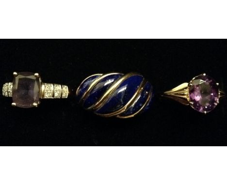 A lapis lazuli five panel cresting ring, each divided by an arcing gold ribbon, 9ct gold shank, size M; a diamond and amethys