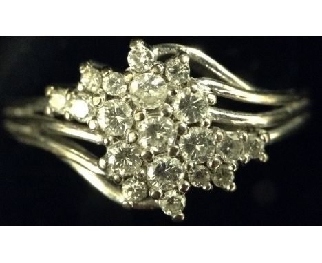 A diamond cluster ring, open wire work free form crest, encrusted with nineteen round brilliant cut diamonds, total diamond w