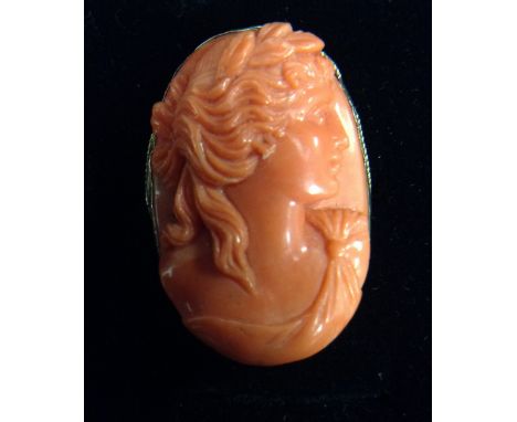 A 19th century carved coral portrait brooch, classical maiden facing left, unmarked yellow metal rope twist frame, 32mm x 23m