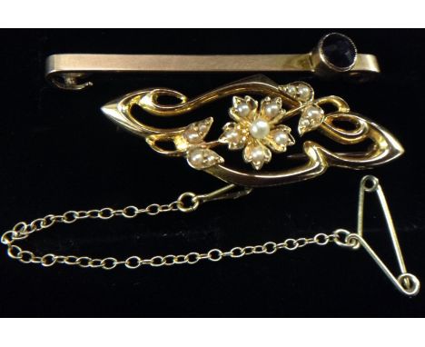 An Edwardian seed pearl brooch, central flower head encrusted with six seed pearls, flanked by two three pearl leaf terminals