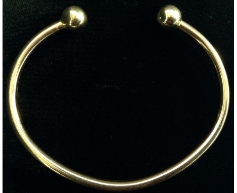 A 9ct gold slave bangle, ball terminals, stamped 375, 14.7g gross