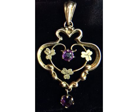 An Edwardian Art Nouveau amethyst and 9ct gold open floral heart shaped pendant, suspending a single amethyst droplet, Cheste