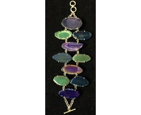 A banded and fortification agate multi-colour panel bracelet, ten individual panels, mounted to a white metal double row chai