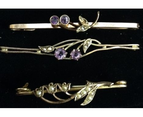 An Edwardian amethyst and seed pearl bar brooch, open oval centre, 9ct rose gold bar;  another smaller;  an Art Nouveau seed 