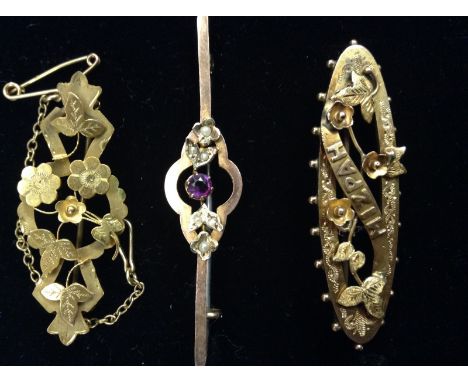 An Edwardian amethyst and seed pearl bar brooch, central open quarter lobbed frame, inset with a single round cut amethyst an