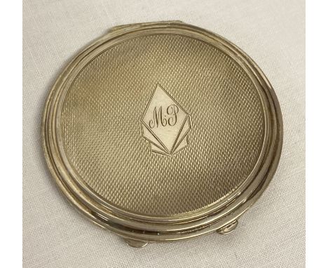 An Edwardian antique silver compact with engine turned decoration and initialled cartouche to front.  Complete with powder pu