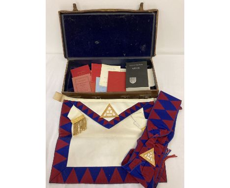 A vintage Masonic cowhide case containing a quantity of Royal Arch Companions Regalia and books.  To include Apron and sash. 