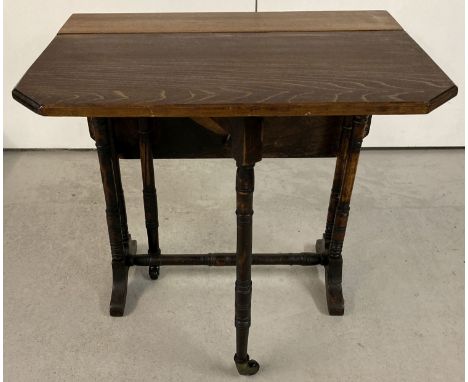 An antique small Sutherland table with turned legs and supports with original ceramic casters.  Extended approx. 66 x 55 x 57