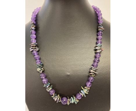 A 20" amethyst and peacock keshi pearl necklace, with white metal S shaped clasp.  