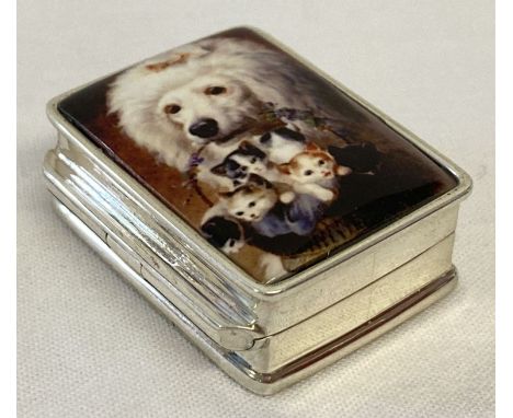 A small white metal pill box marked "Sterling" with ceramic plaque to lid.  Lid shows a dog carrying a basket of kittens.  Ap