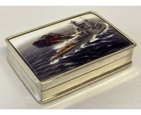A white metal pill box with ceramic lid depicting a battleship. Box stamped 925.   Approx. 1.25 x 5 x 3.5cm.