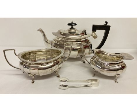 A Victorian matching silver plate teapot, sugar bowl and milk jug.   Together with a pair of silver plated sugar tongs marked