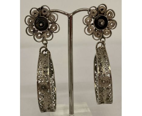A pair of vintage screw back, filigree design, drop style earrings. Flower detail to tops with scroll work hoop drops. Indist