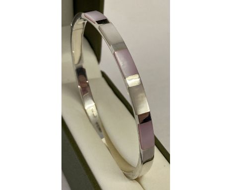 A modern design silver hinged bangle set with pale pink and white shell.  Marked 925 with scales to inside of bangle. 