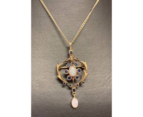 An Art Nouveau style 9ct gold lavaliere pendant set with sapphire and opals.  On a 9ct gold curb chain. Classic design pendan