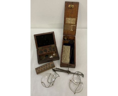 A wooden cased set of Victorian apothecary scales with glass trays and weights.  Together with a box of weights (not complete