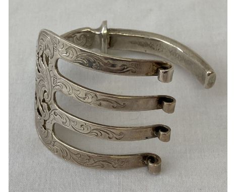 A silver bangle made from a decorative Victorian serving fork.  Hallmarked Arron Hadfield, Sheffield, 1851.  Total weight app