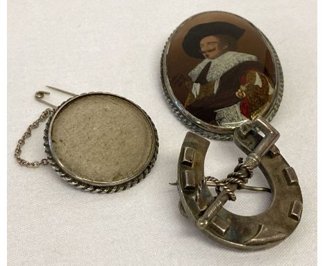 3 vintage silver brooches. A vintage horseshoe with riding crop detail.  Together with a silver mounted brooch depicting the 
