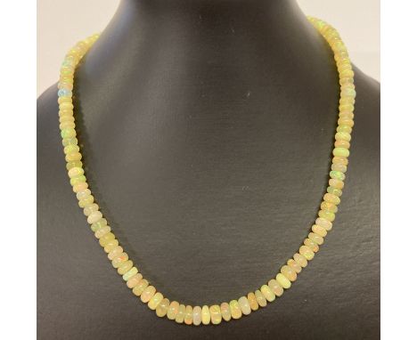 An 18 inch opal bead necklace with 9ct gold clasp. 100 cts of round cut opal beads.  In original necklace case. Varying iride