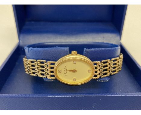 A boxed ladies 9ct gold wristwatch by Rotary. Face set with 4 small diamonds.  Complete with instruction book and diamond cer