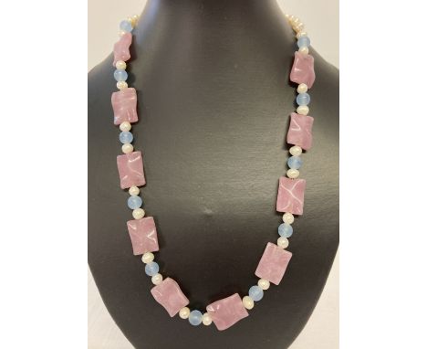 A 22" fresh water pearl necklace with pink and blue jade beads and gold tone hook clasp.  